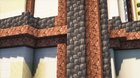 'Clean' way to make these towers intersect the ring? The granite walls on the towers have this ugly break where the stairs cut across.